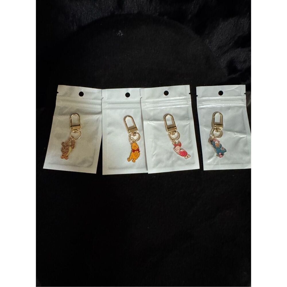 Brand New set of four Disney bag charms or key chains